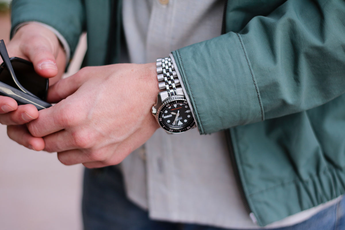 Person with Seiko watch, sunglasses.