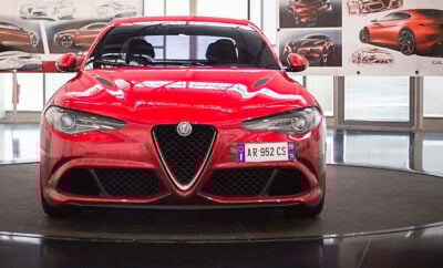 Red Alfa Romeo in showroom.